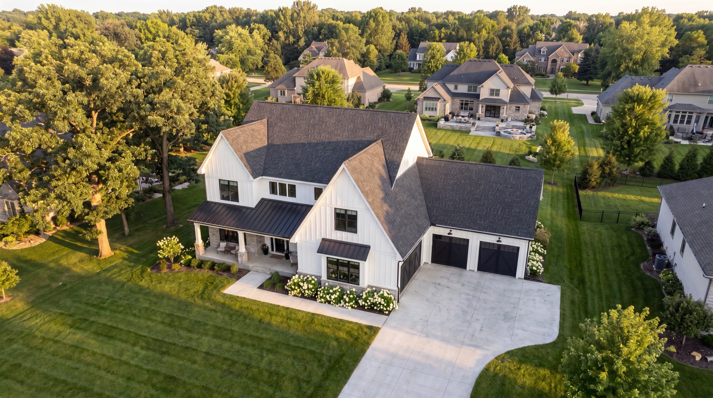 Aerial drone photo of a modern farmhouse and its neighborhood